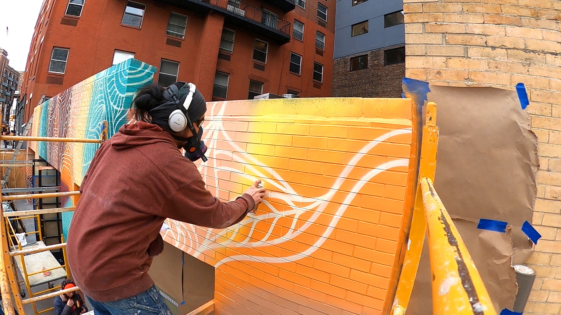 Shogo Ota spray painting colorful mural in New York